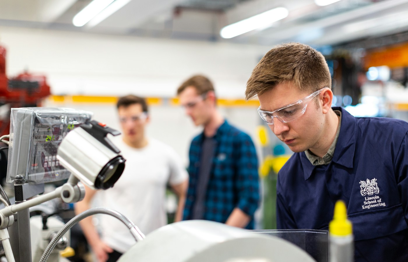 Engineer operating machinery in a modern workshop